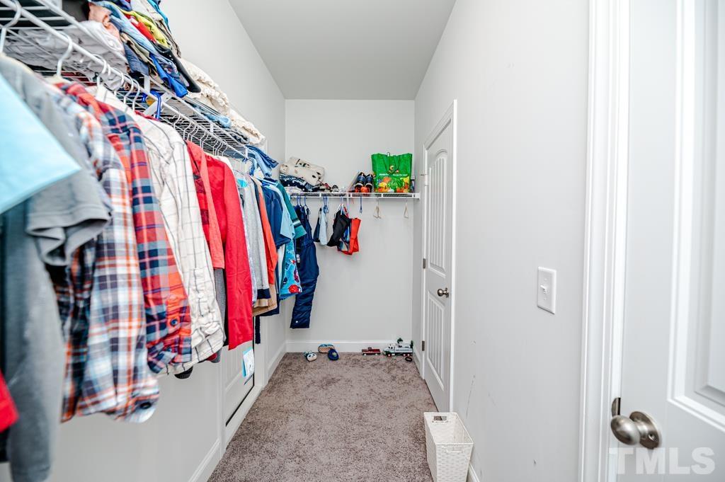 6712 Lucado Court Raleigh, NC 27603 - Photo 40 of 52 a view of walk in closet with clothes