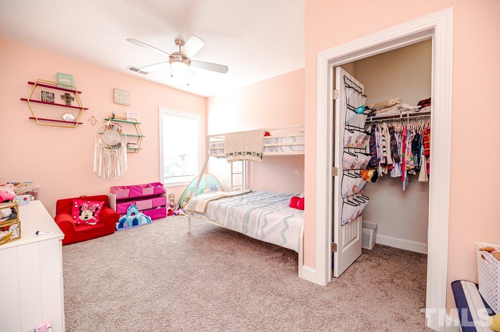 6712 Lucado Court Raleigh, NC 27603 - Photo 41 of 52 a bed room with a bed and a chandelier