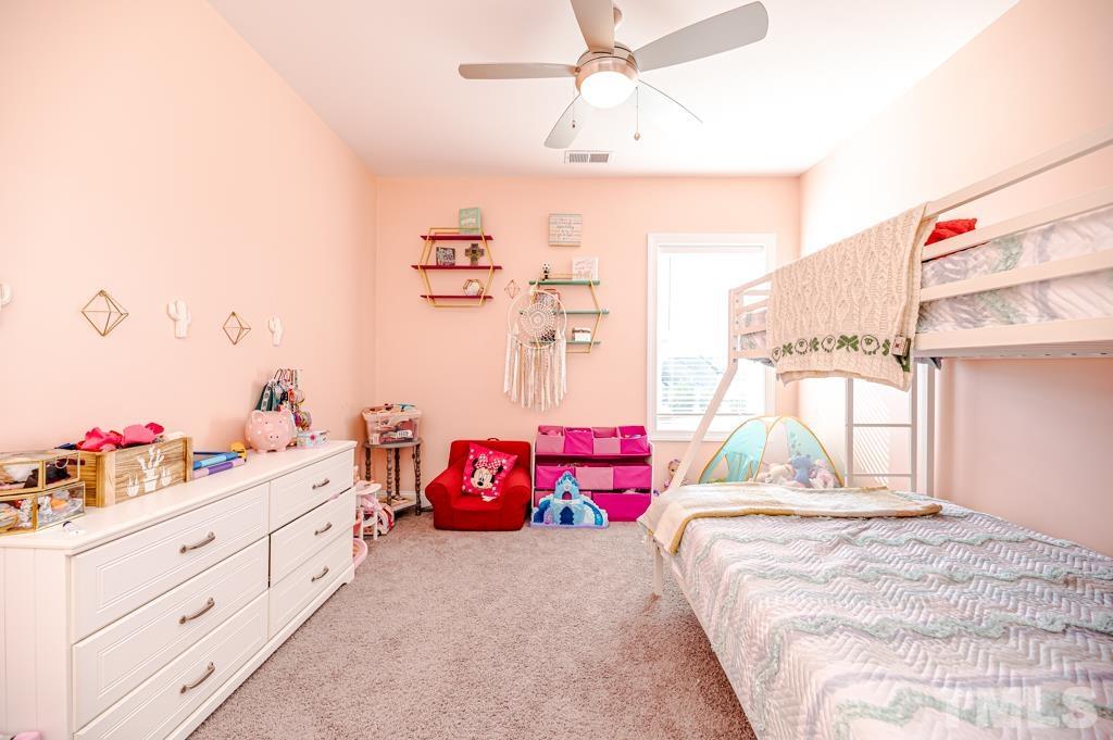 6712 Lucado Court Raleigh, NC 27603 - Photo 42 of 52 a bedroom with a bed and a window
