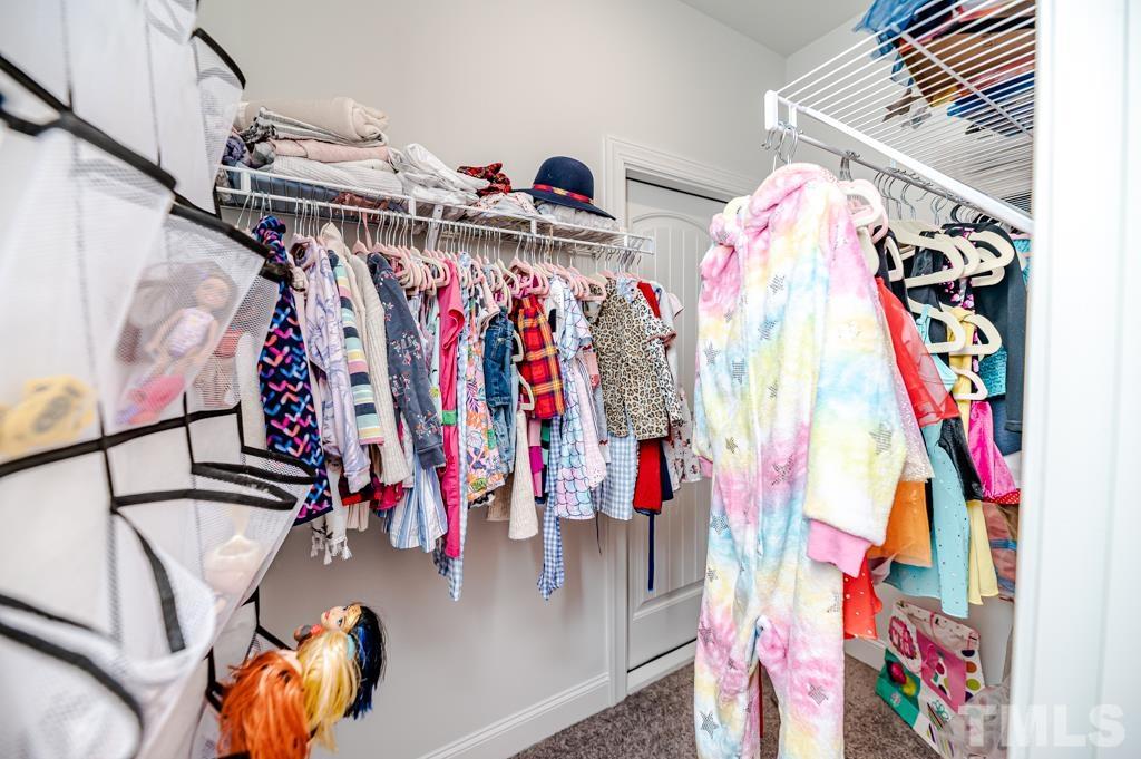 6712 Lucado Court Raleigh, NC 27603 - Photo 43 of 52 a view of walk in closet with clothes