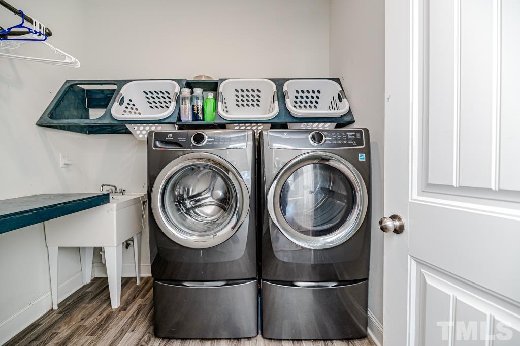 6712 Lucado Court Raleigh, NC 27603 - Photo 45 of 52 a view of a storage & utility room with washer and dryer