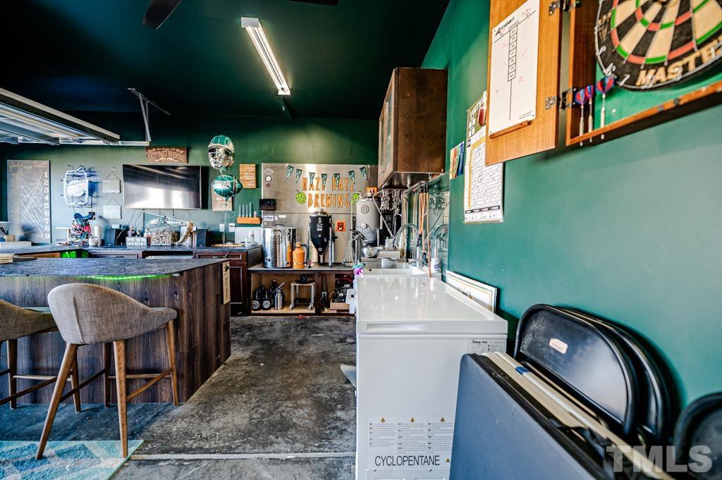 6712 Lucado Court Raleigh, NC 27603 - Photo 46 of 52 a kitchen with a sink a table and chairs