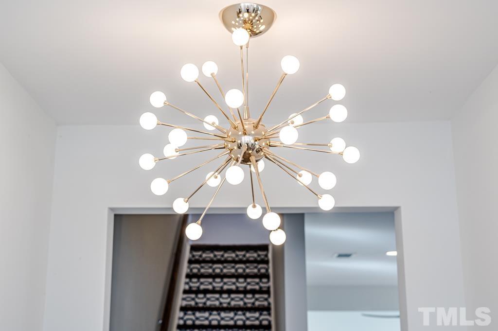 6712 Lucado Court Raleigh, NC 27603 - Photo 8 of 52 a bathroom with a light fixture and a chandelier