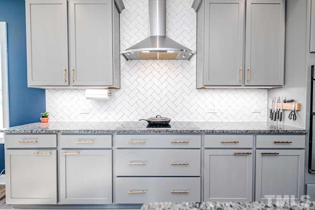 6712 Lucado Court Raleigh, NC 27603 - Photo 10 of 52 a kitchen with granite countertop white cabinets and a sink