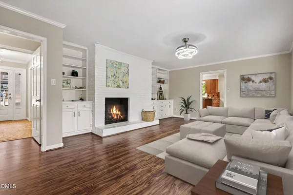 a living room with furniture a fireplace and a flat screen tv