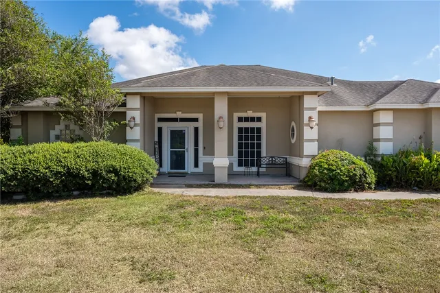 a view of a house with backyard and porch