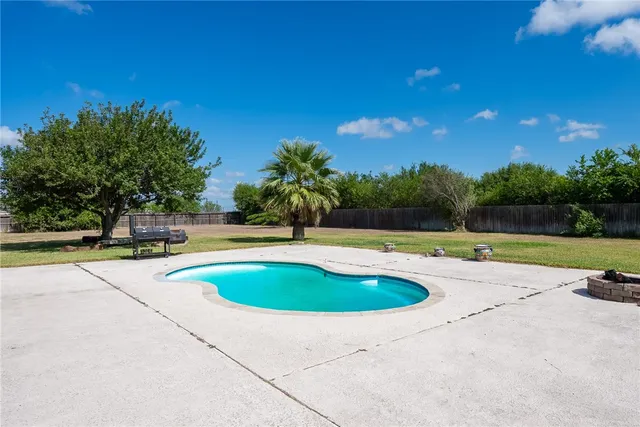 a view of swimming pool with a yard