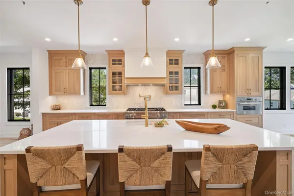 a kitchen with a table chairs stove and kitchen island