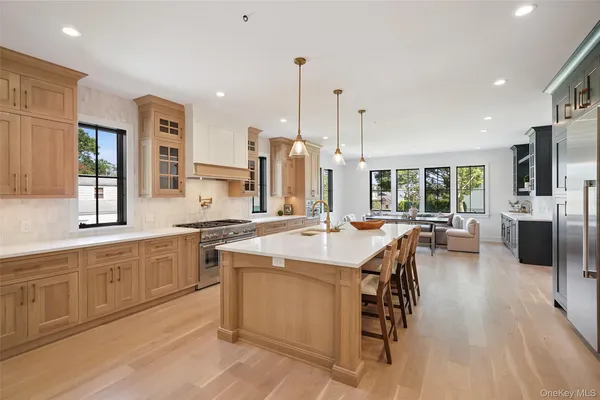 a large kitchen with a large counter top appliances and cabinets