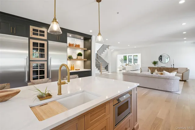 a kitchen with stainless steel appliances granite countertop a sink and a microwave