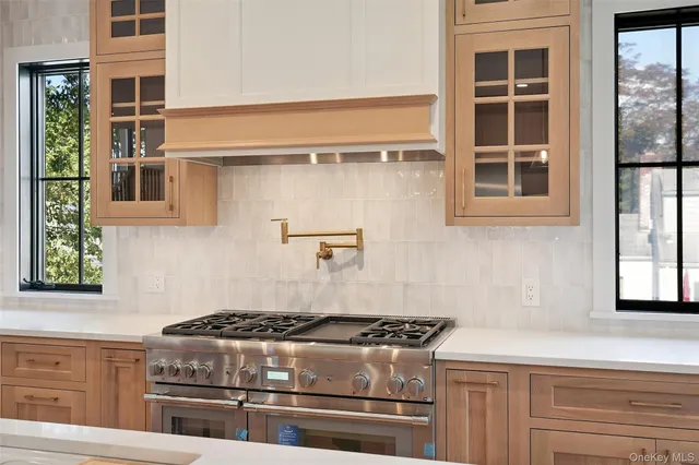a stove top oven sitting inside of a kitchen