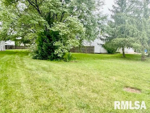 a view of a field of grass and trees