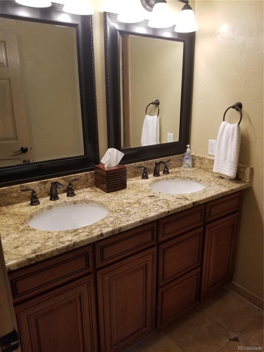 10 Shotgun Circle Edwards, CO 81632 - Photo 12 of 33 a bathroom with a granite countertop sink and a mirror