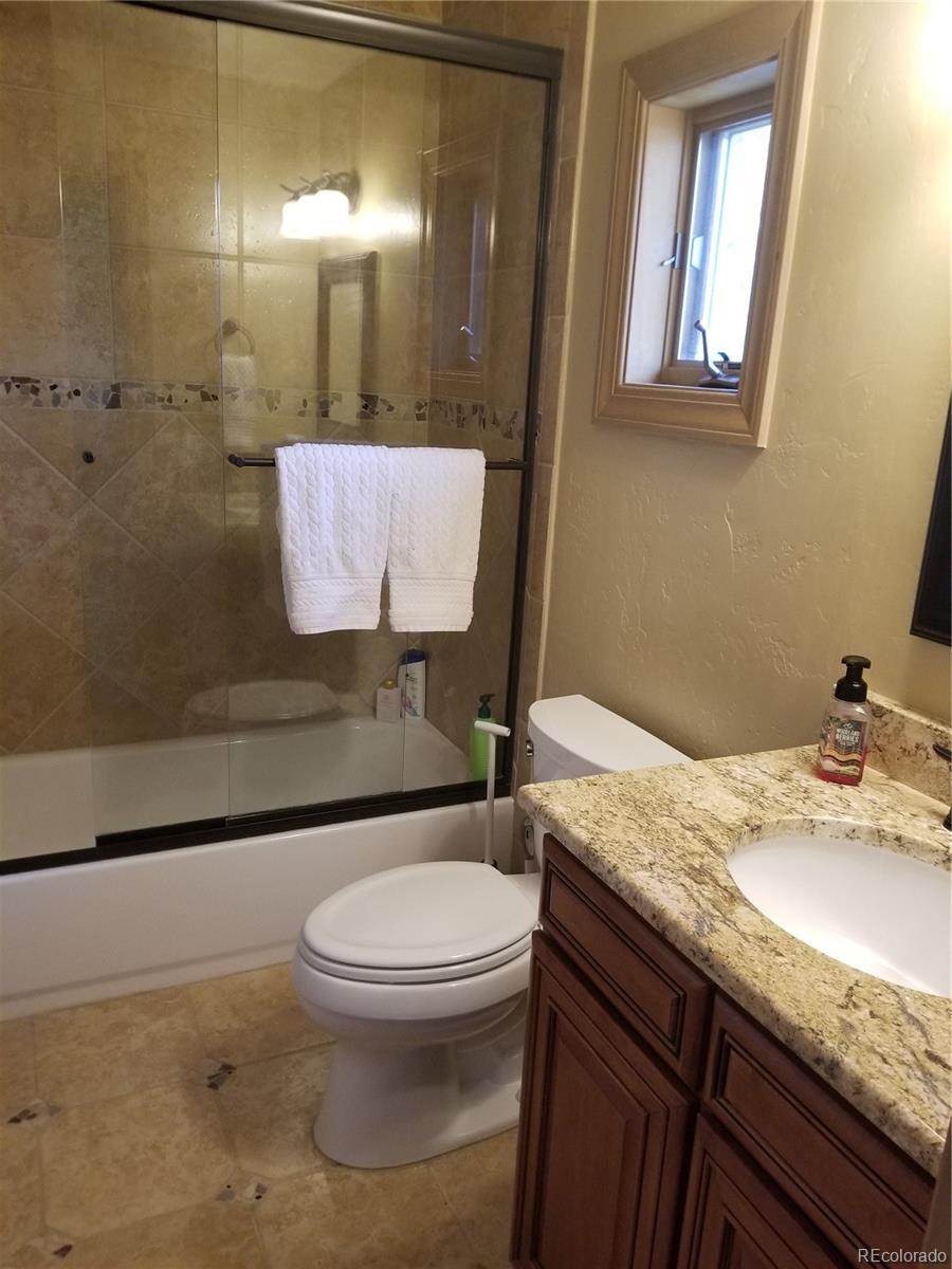 10 Shotgun Circle Edwards, CO 81632 - Photo 14 of 33 a bathroom with a granite countertop toilet sink and mirror