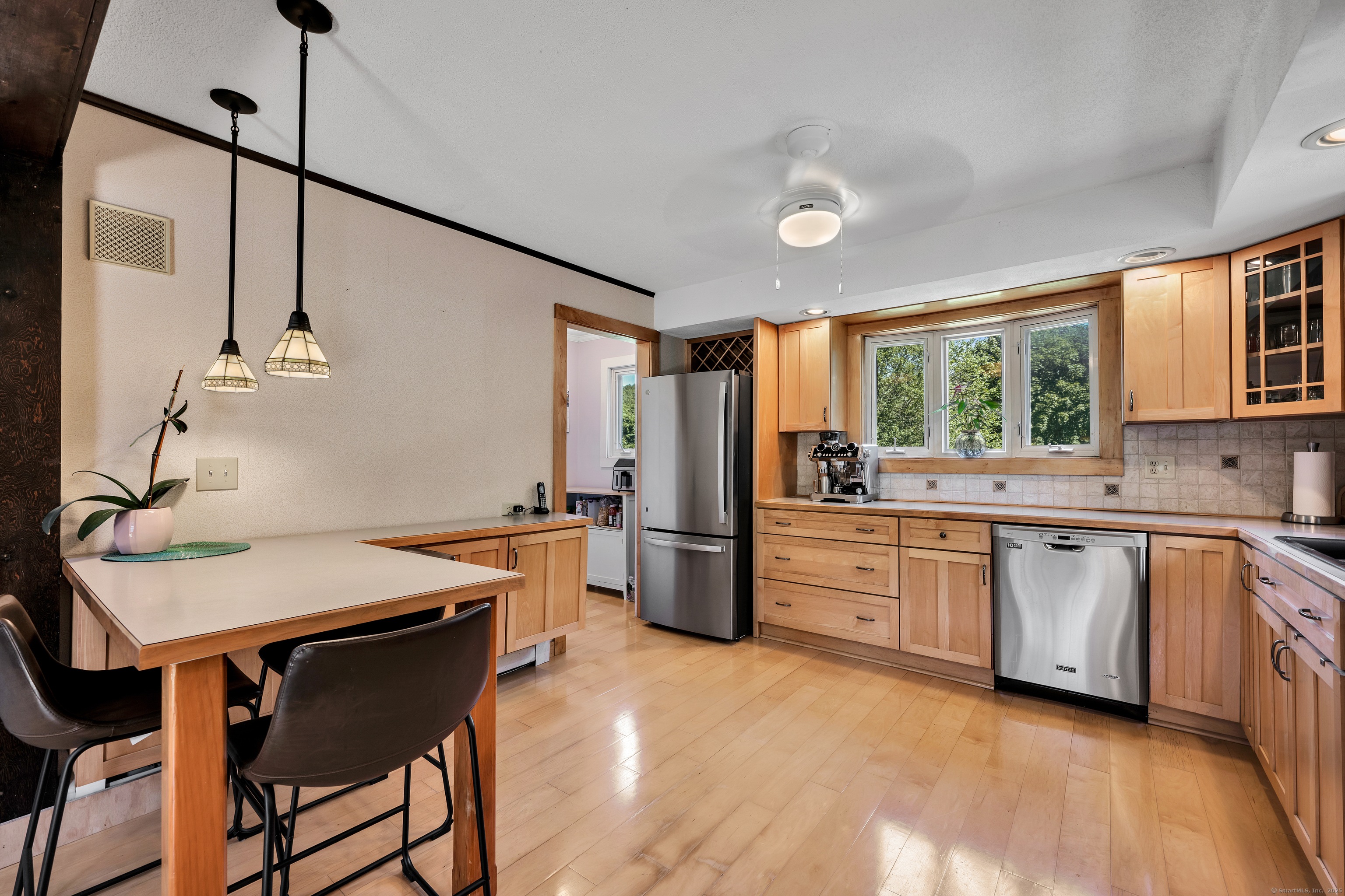 21 Long Meadow Road Bethlehem, CT 06751 - Photo 16 of 32 a kitchen with a table chairs stove and refrigerator