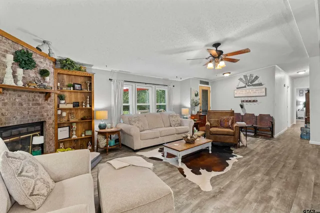 a living room with furniture fireplace and a window