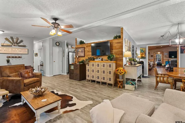 a kitchen with stainless steel appliances kitchen island granite countertop a table and chairs in it