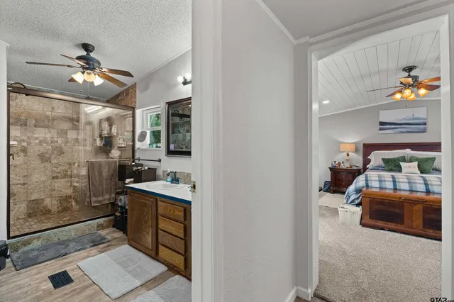 a bathroom with a double vanity sink mirror and shower