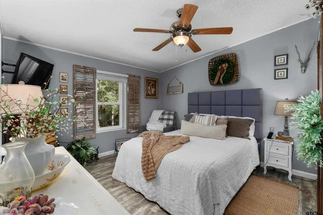 a bedroom with a bed and a television