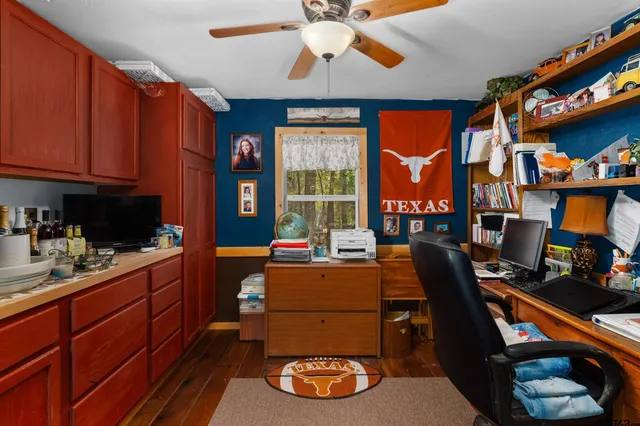a kitchen with a sink a stove and a wooden floor