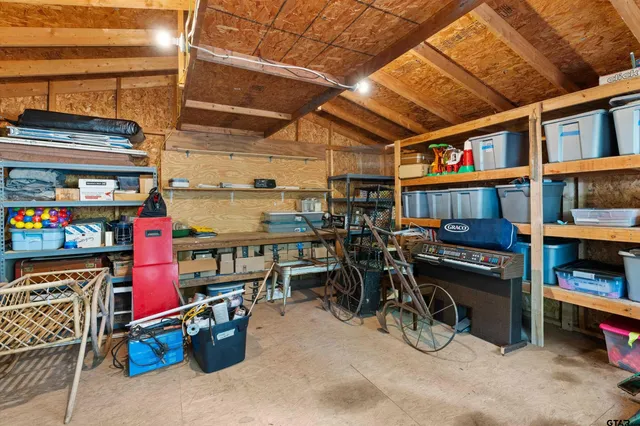 a view of parking garage with a bike and car