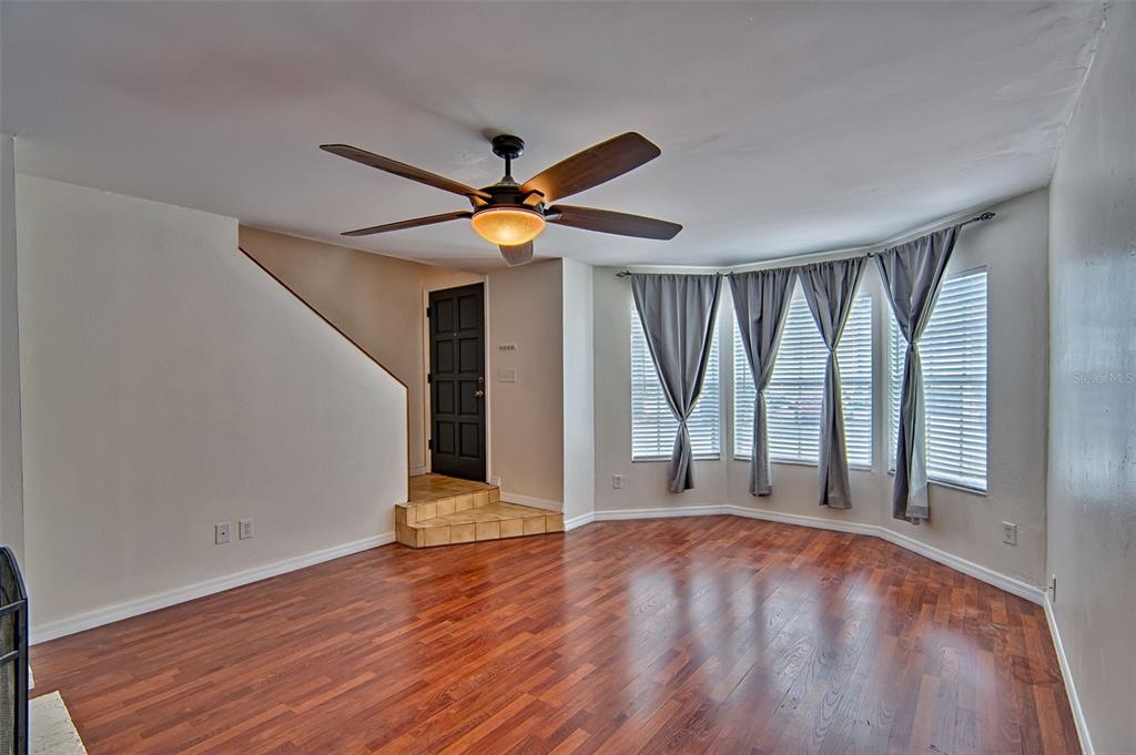 2305 Southwest 73rd Terrace Gainesville, FL 32607 - Photo 3 of 21 wooden floor in an empty room with a window