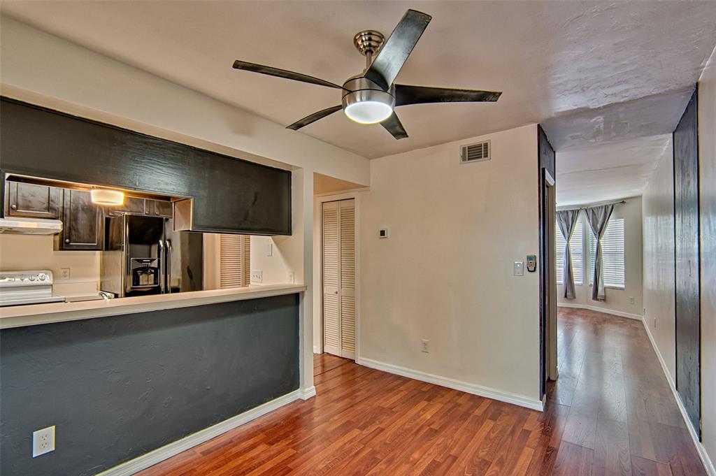 2305 Southwest 73rd Terrace Gainesville, FL 32607 - Photo 5 of 21 a view of a hallway with wooden floor and a ceiling fan