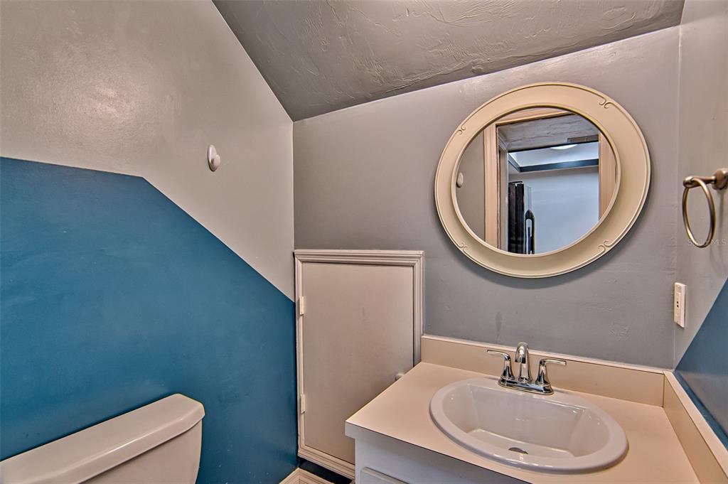 2305 Southwest 73rd Terrace Gainesville, FL 32607 - Photo 9 of 21 a bathroom with a toilet a sink and a mirror