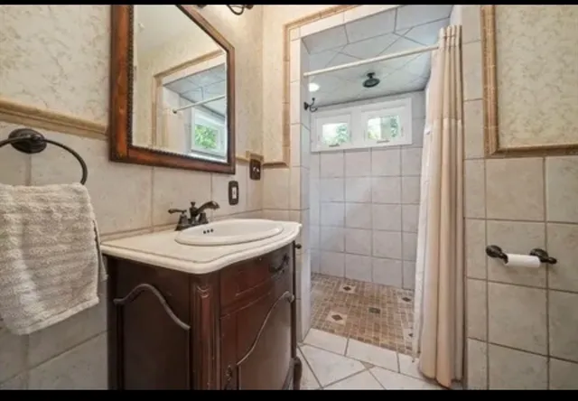 a view of a livingroom with wooden floor and a fireplace