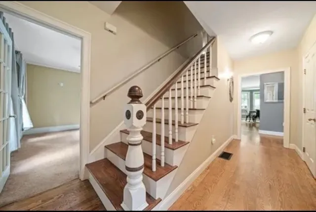 a view of entryway and hall with wooden floor