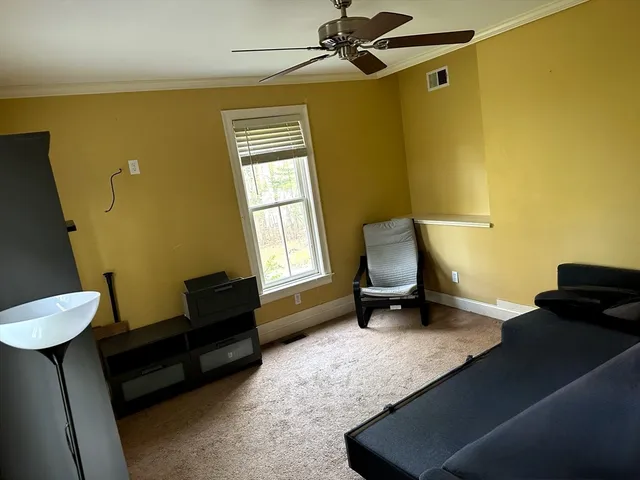 a bedroom with furniture and a window