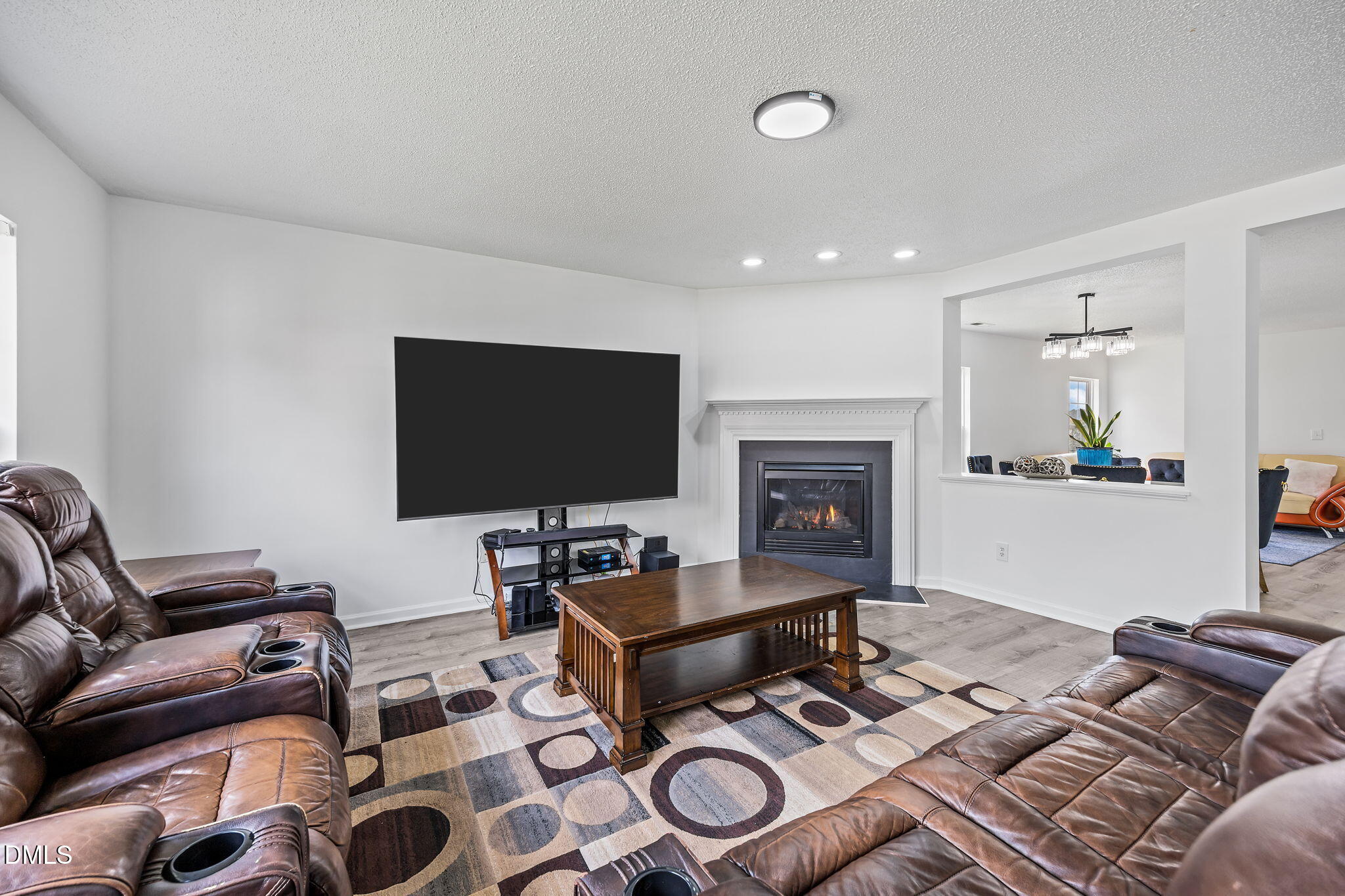 6307 Quitman Trail Raleigh, NC 27610 - Photo 13 of 35 a living room with furniture a flat screen tv and a fireplace