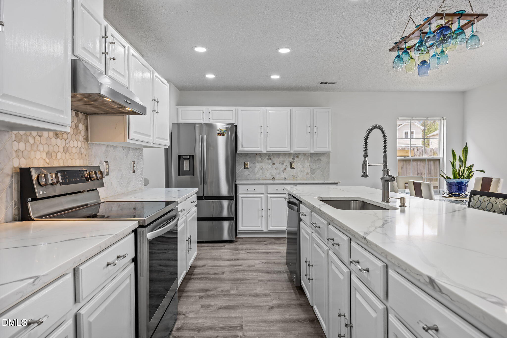 6307 Quitman Trail Raleigh, NC 27610 - Photo 15 of 35 a kitchen with stainless steel appliances granite countertop a sink stove and refrigerator