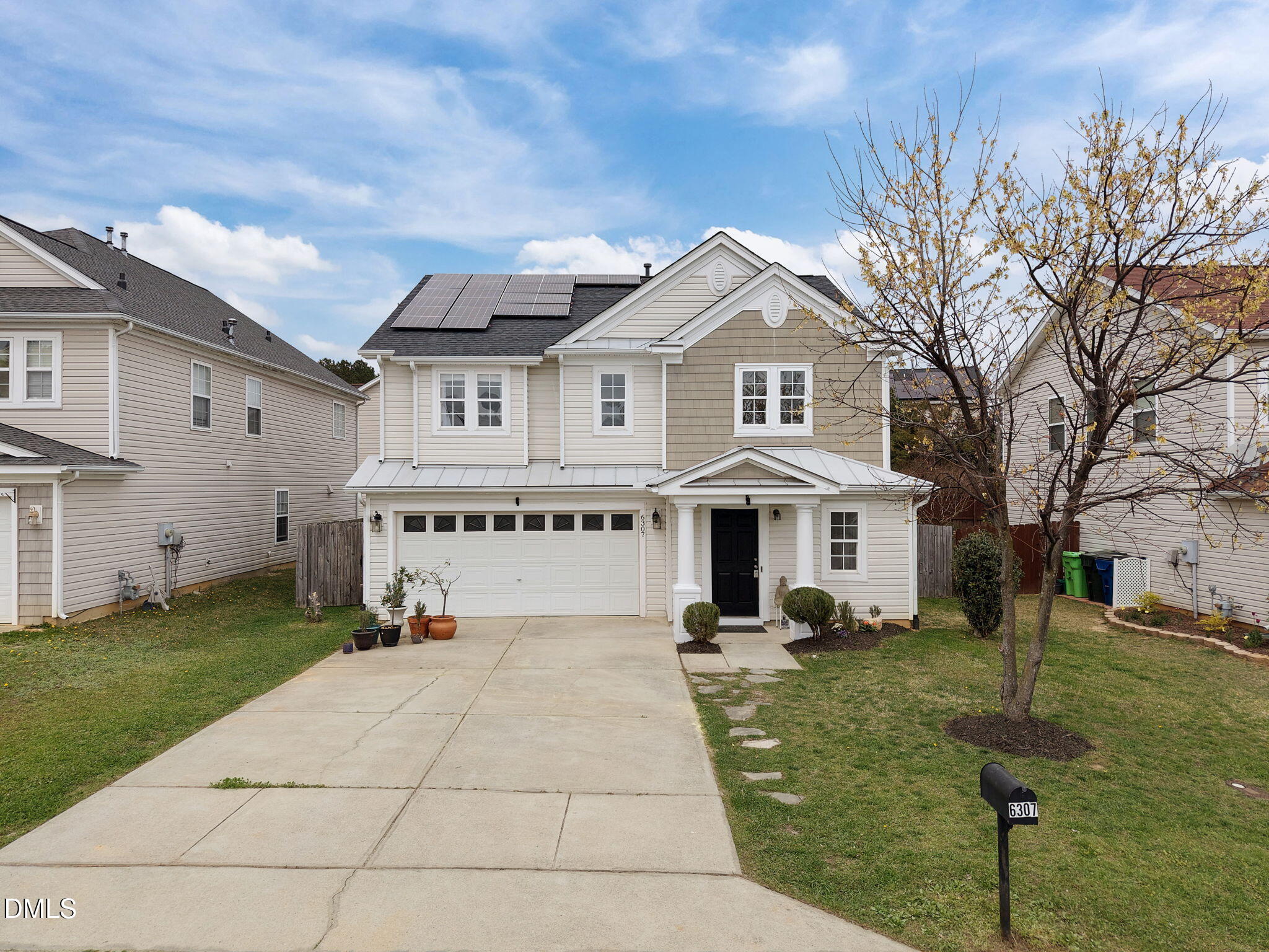 6307 Quitman Trail Raleigh, NC 27610 - Photo 2 of 35 a view of a white house with a big yard and potted plants