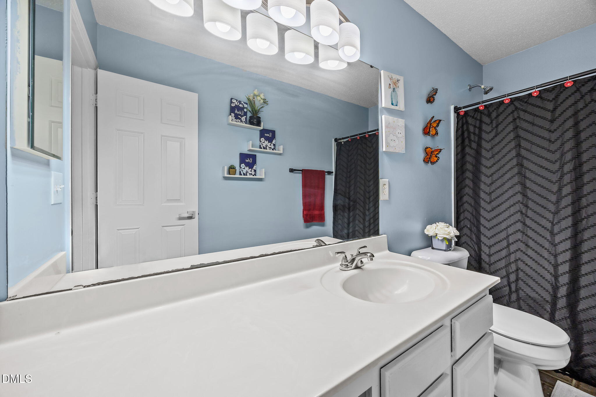 6307 Quitman Trail Raleigh, NC 27610 - Photo 30 of 35 a bathroom with a sink vanity mirror and toilet