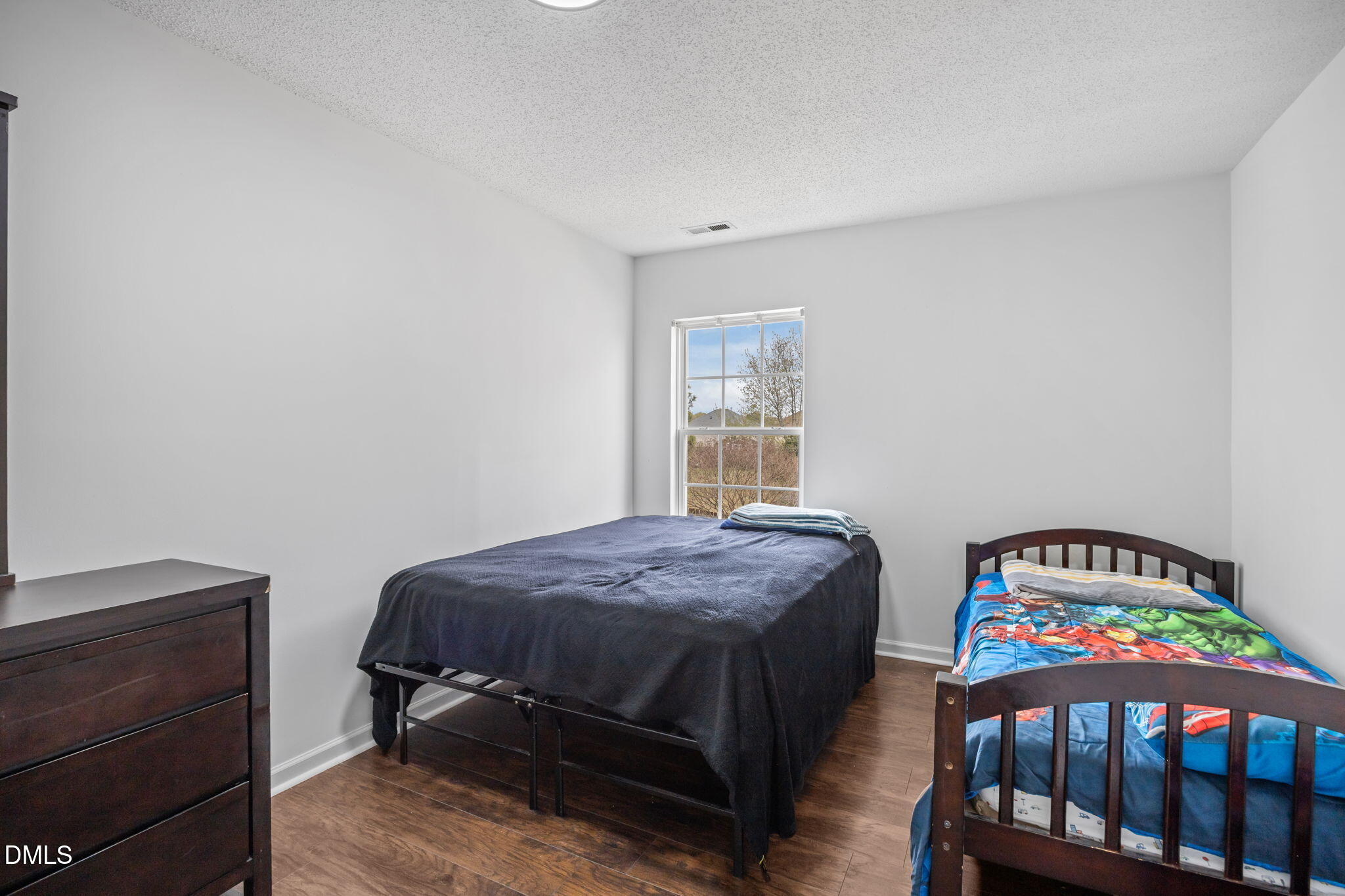 6307 Quitman Trail Raleigh, NC 27610 - Photo 31 of 35 a bedroom with a bed a baby crib and a window