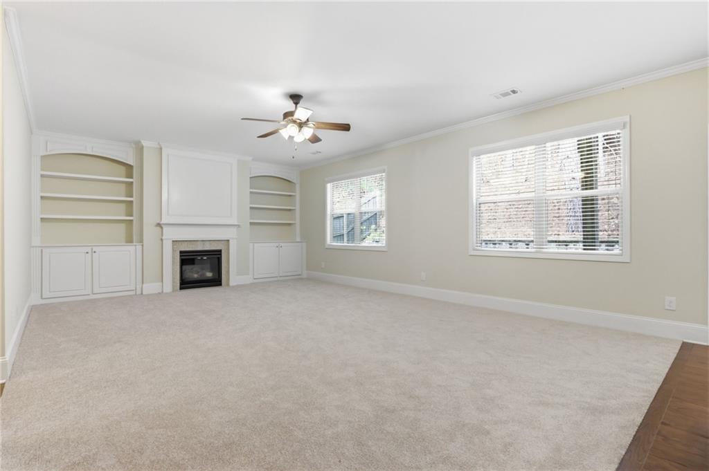 1515 Riva Ridge Suwanee, GA 30024 - Photo 9 of 35 an empty room with windows and fireplace