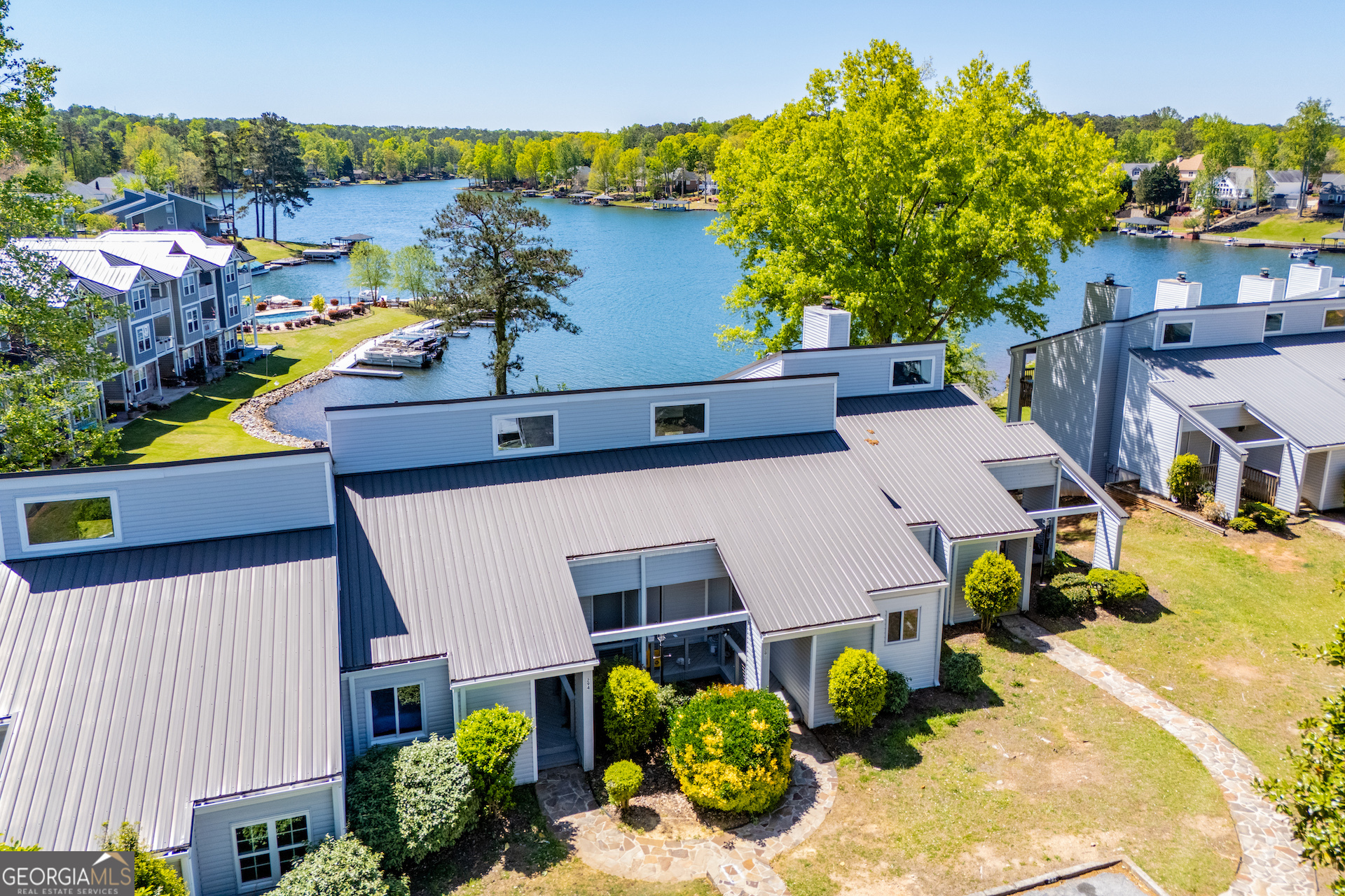 an aerial view of multiple houses with yard