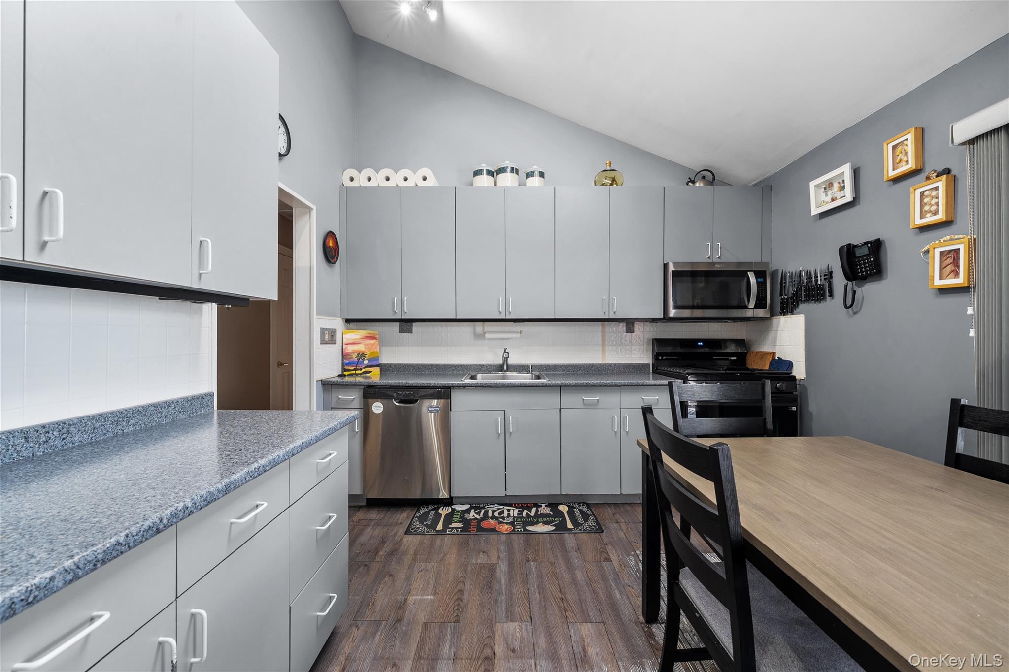 34 West 21st Street Deer Park, NY 11729 - Photo 11 of 33 a kitchen with kitchen island granite countertop stainless steel appliances and wooden cabinets
