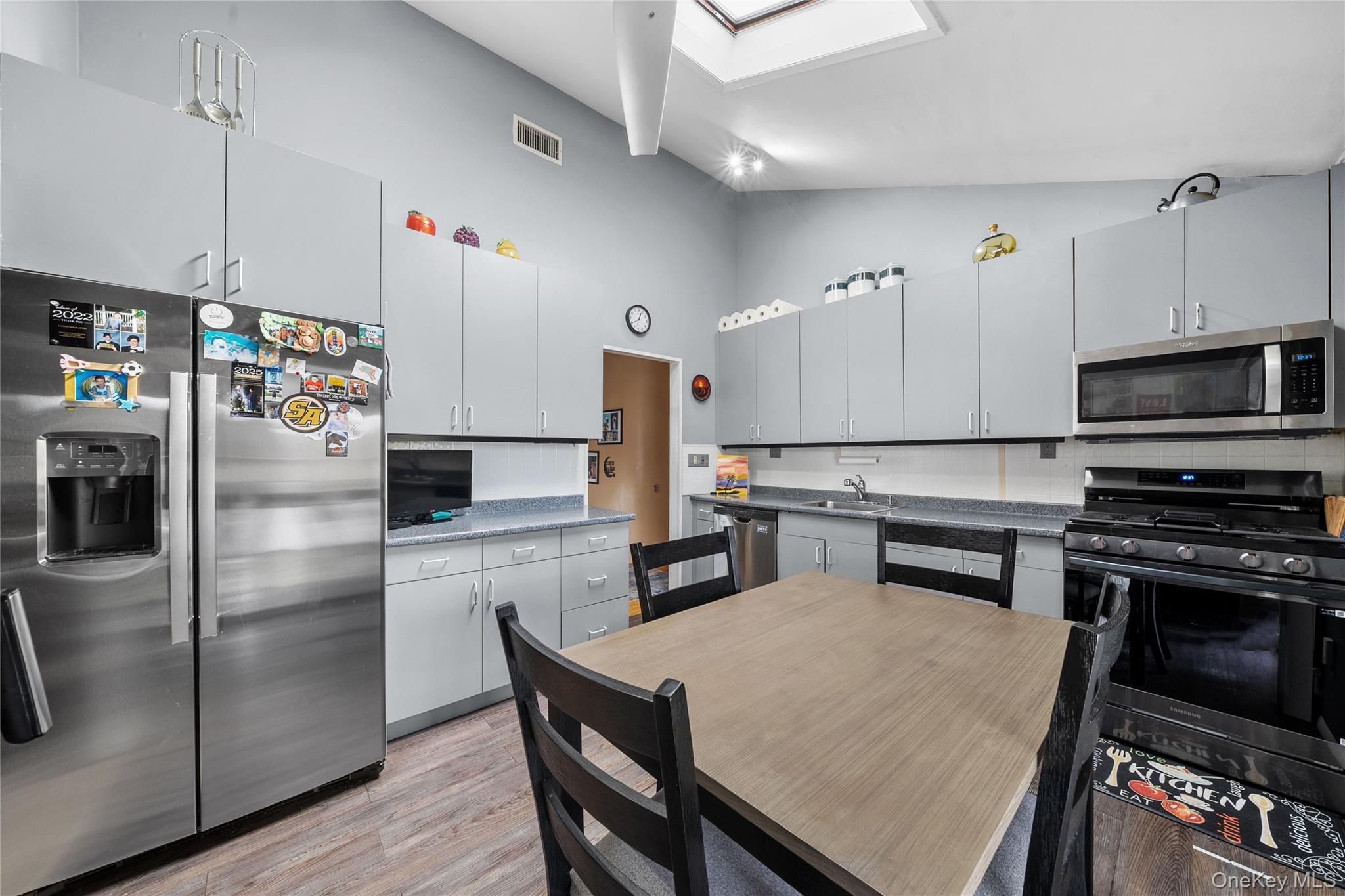 34 West 21st Street Deer Park, NY 11729 - Photo 13 of 33 a kitchen with refrigerator cabinets and wooden floor