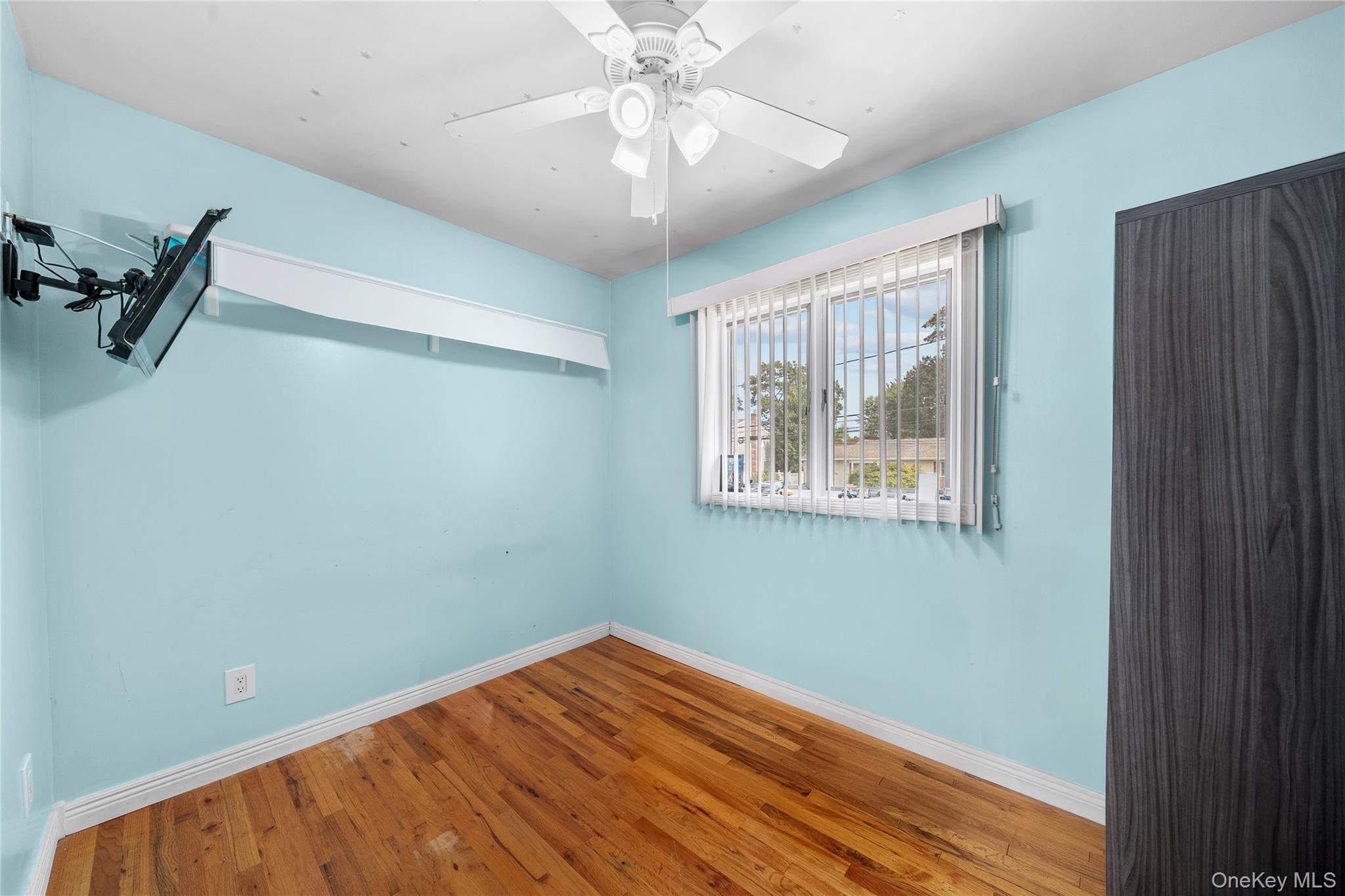 34 West 21st Street Deer Park, NY 11729 - Photo 17 of 33 a view of empty room with wooden floor and fan