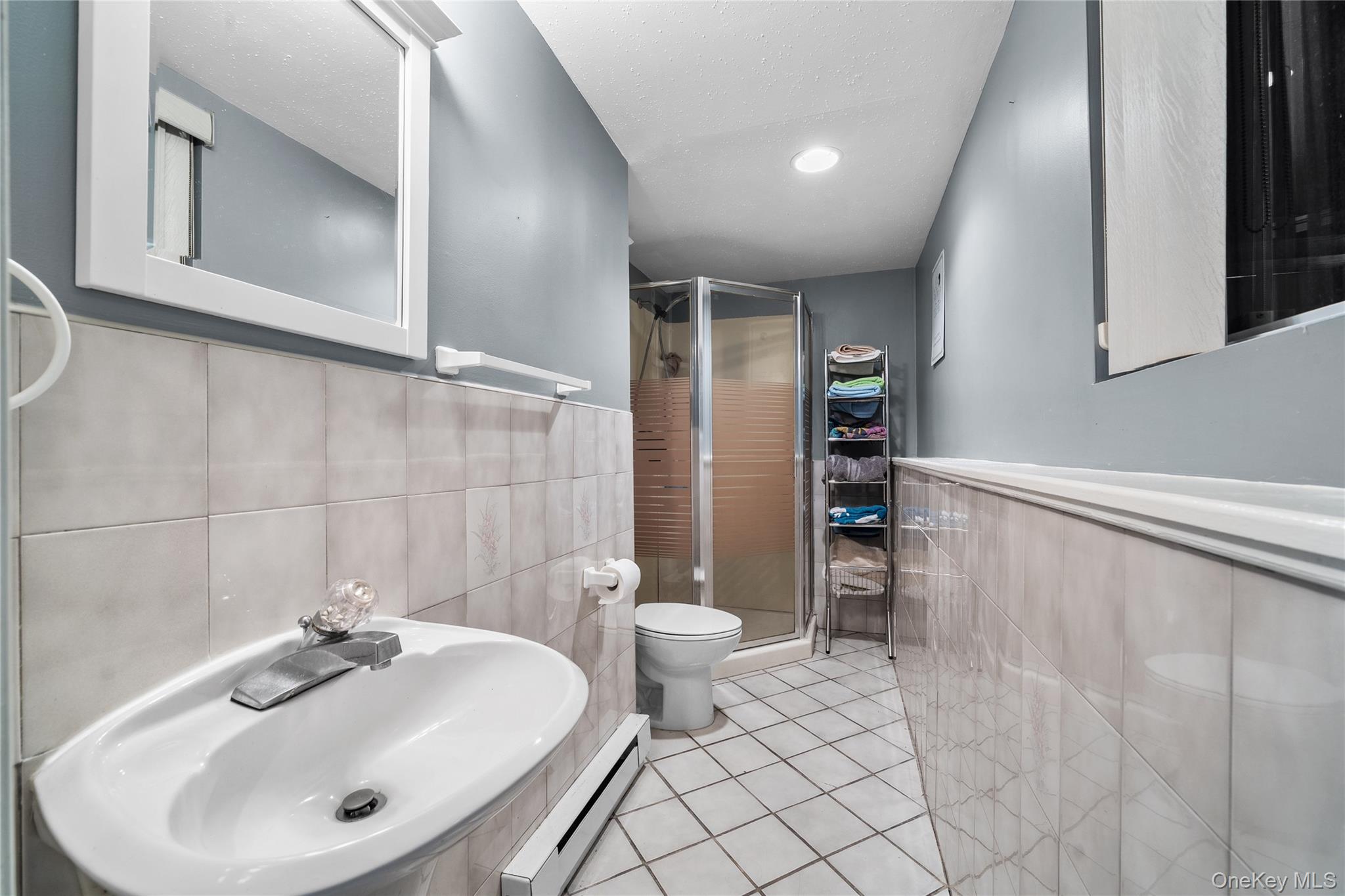 34 West 21st Street Deer Park, NY 11729 - Photo 22 of 33 a bathroom with a sink a toilet and shower