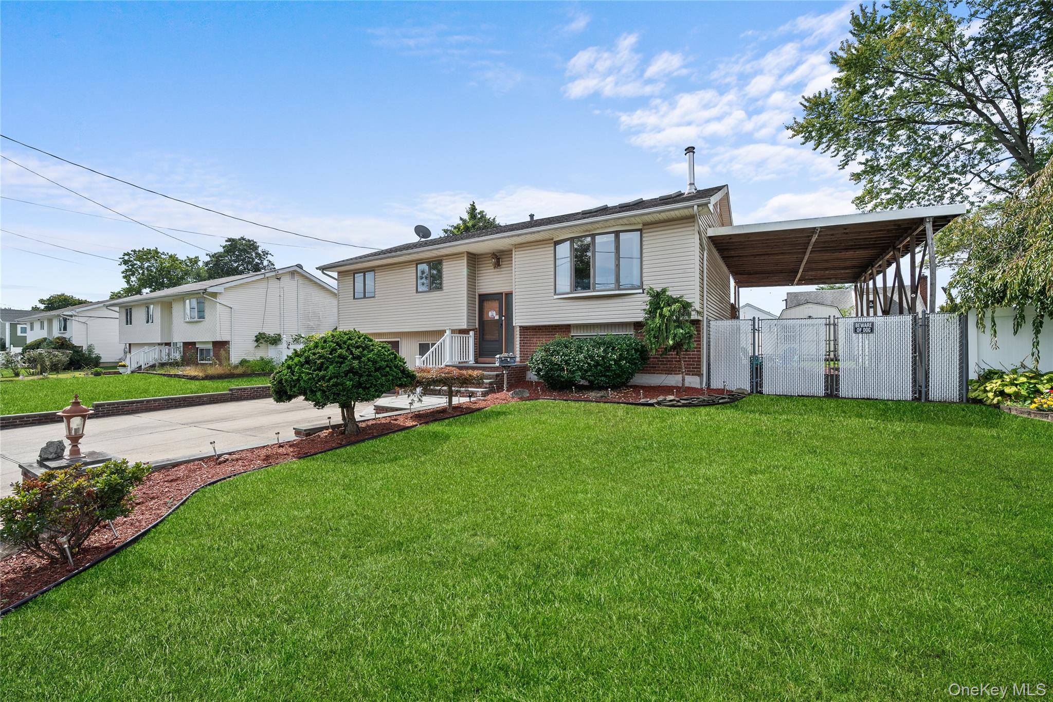 34 West 21st Street Deer Park, NY 11729 - Photo 3 of 33 a front view of a house with a garden and plants