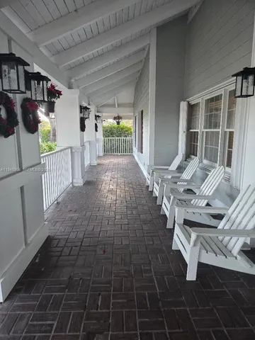 a view of a house with sitting area and a yard