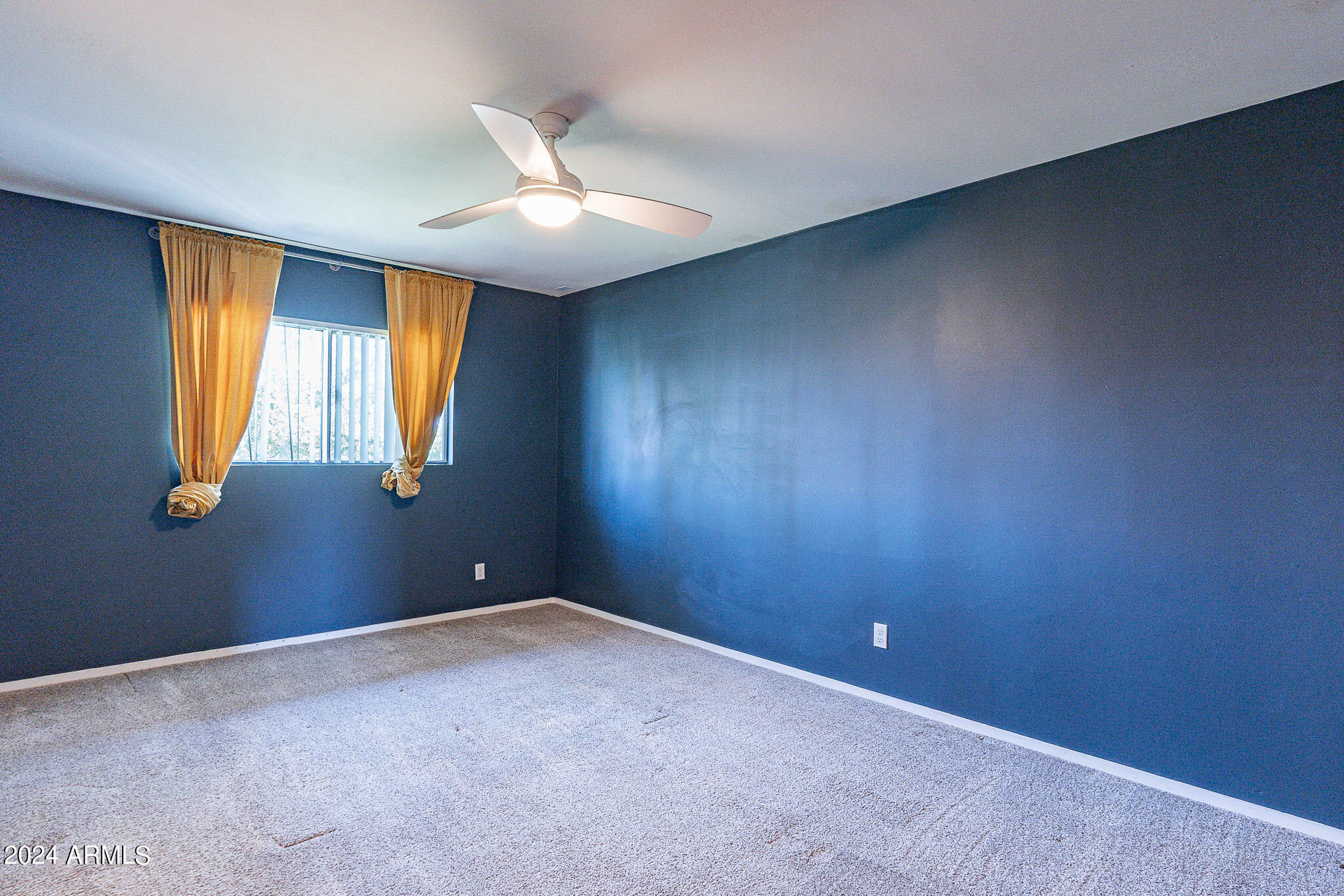 1630 East Georgia Avenue, Unit 204 Phoenix, AZ 85016 - Photo 12 of 23 an empty room with windows and fan