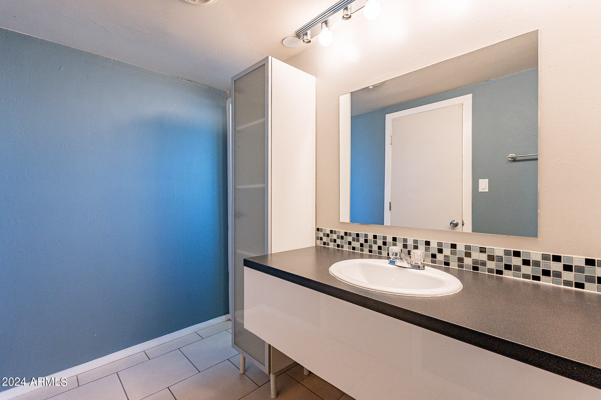 1630 East Georgia Avenue, Unit 204 Phoenix, AZ 85016 - Photo 14 of 23 a bathroom with a sink and a mirror