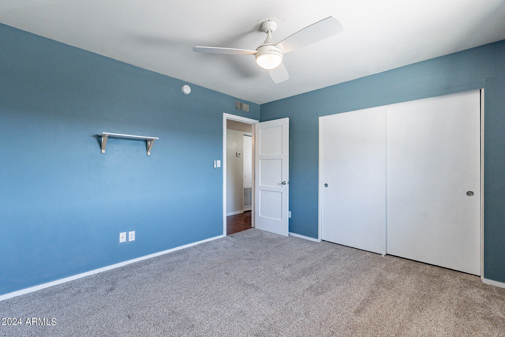 1630 East Georgia Avenue, Unit 204 Phoenix, AZ 85016 - Photo 17 of 23 an empty room with closet and a ceiling fan