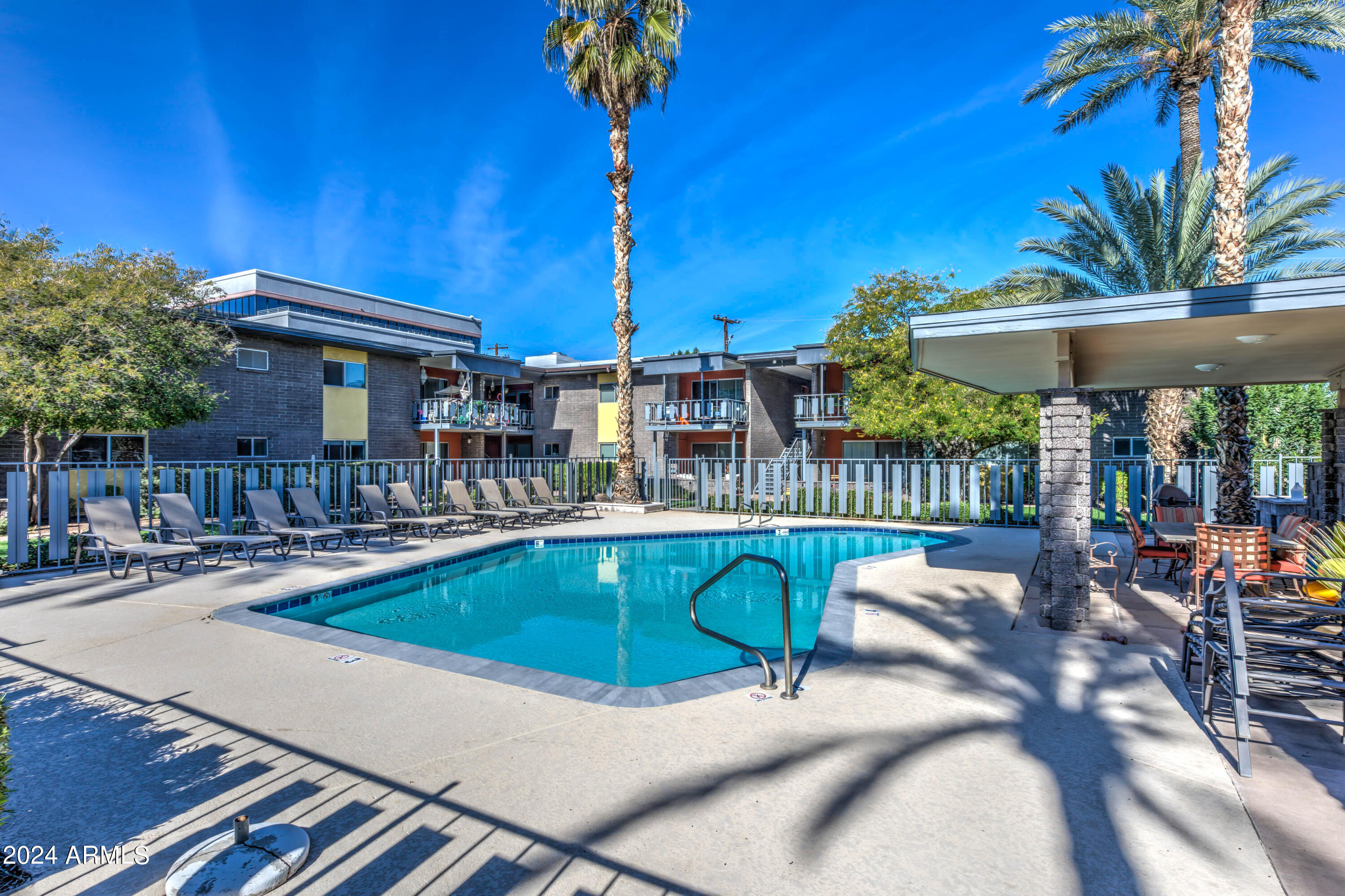 1630 East Georgia Avenue, Unit 204 Phoenix, AZ 85016 - Photo 23 of 23 a swimming pool with outdoor seating and yard