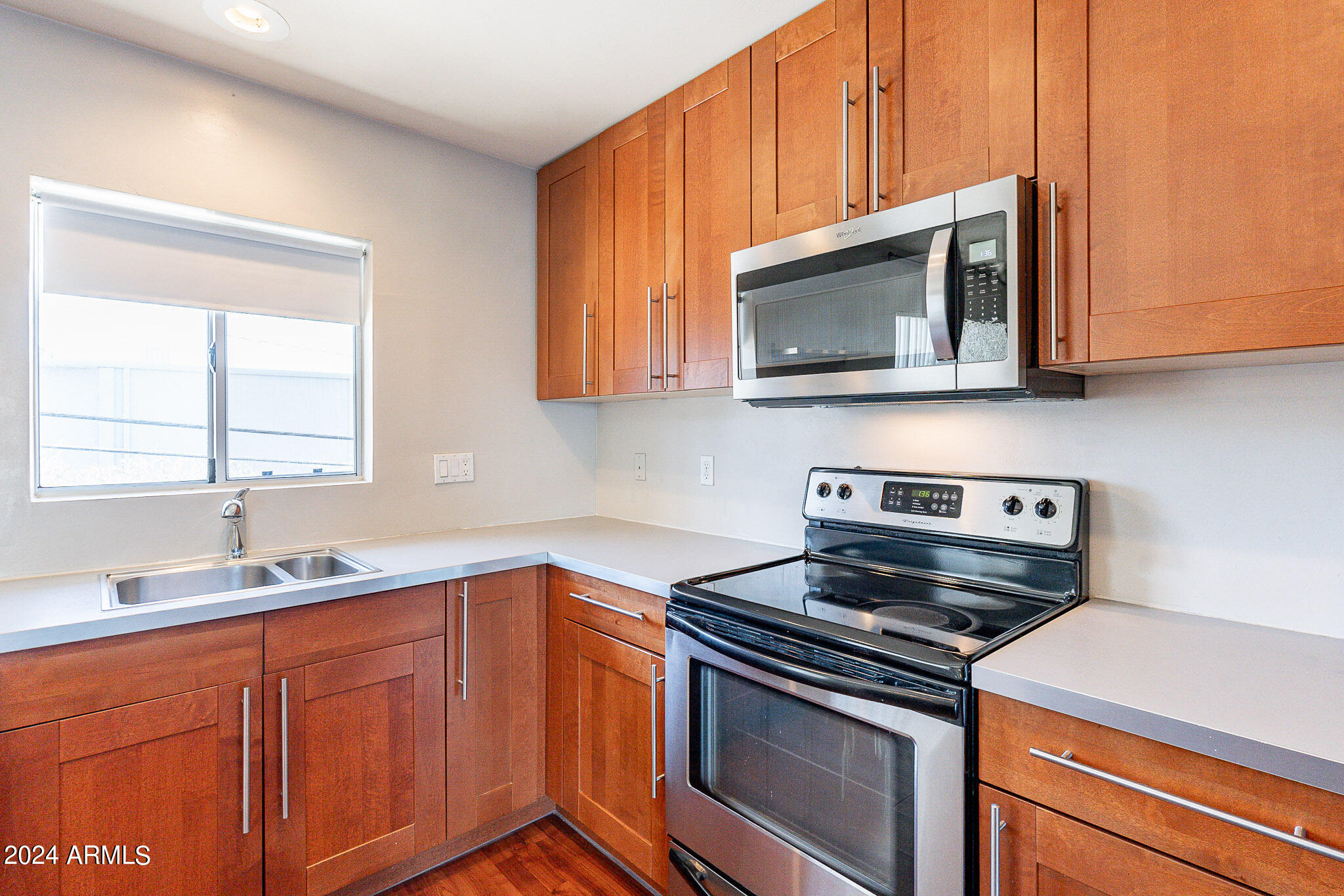 1630 East Georgia Avenue, Unit 204 Phoenix, AZ 85016 - Photo 6 of 23 a kitchen with stainless steel appliances a stove microwave and sink