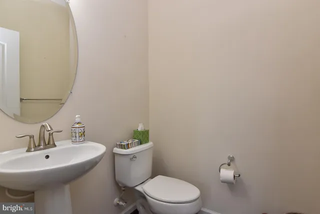 a white toilet sitting next to a bathroom sink